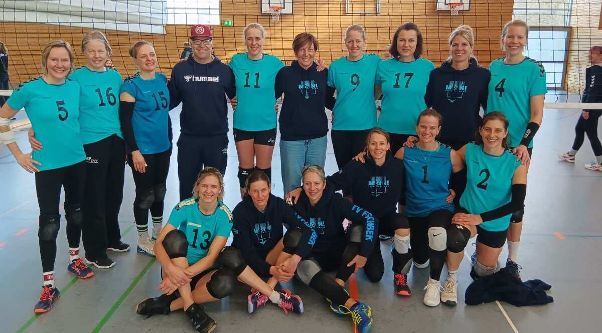 a group of women in blue shirts