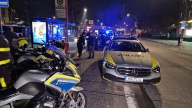 a police car and motorcycle on a street at night