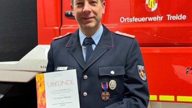 a man in a uniform holding a certificate