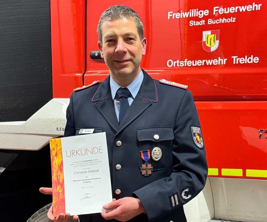 a man in a uniform holding a certificate