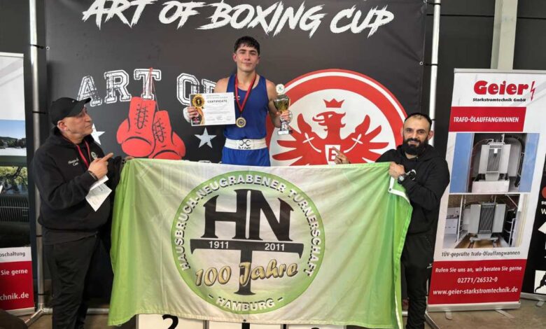 a man holding a trophy and a flag