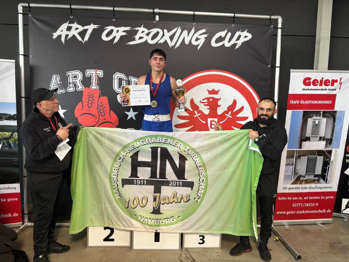 a man holding a trophy and a flag