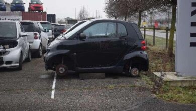 a small black car with wheels on the back