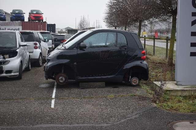 a small black car with wheels on the back