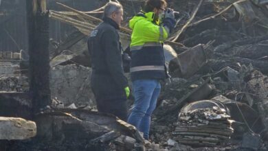 two people standing in a pile of debris