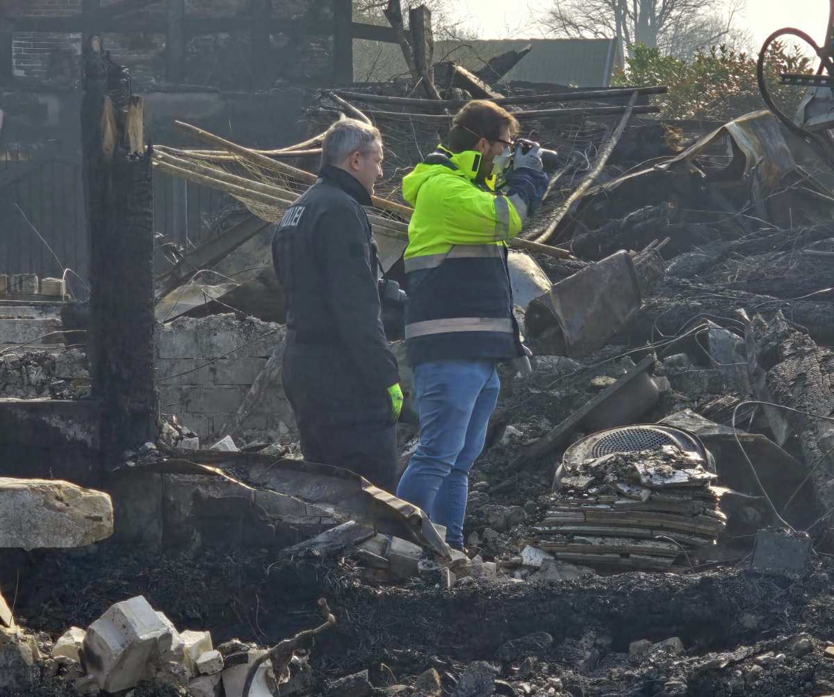two people standing in a pile of debris