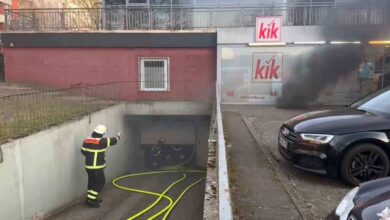 a firefighter in a tunnel with a hose