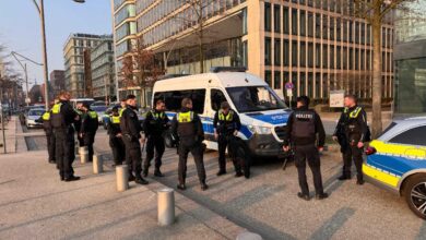 a group of police officers standing in front of a van