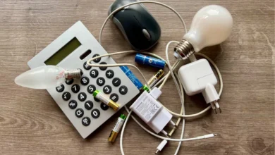 a calculator and light bulbs on a wood surface