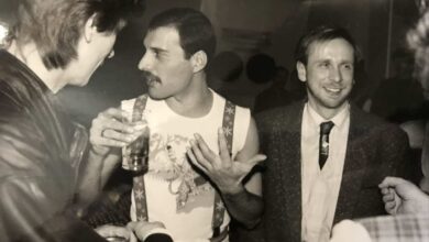a group of men talking and drinking