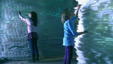 a girl holding a stack of white foam