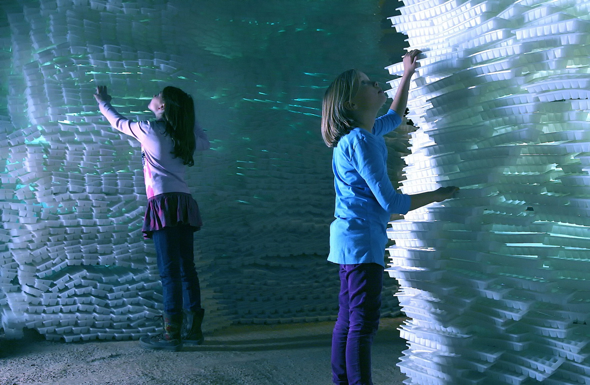 a girl holding a stack of white foam