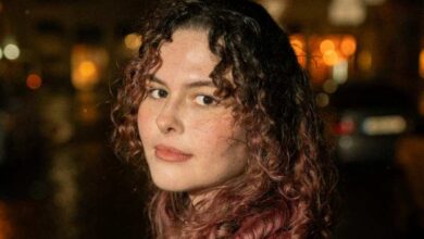 a woman with curly hair and a red shirt