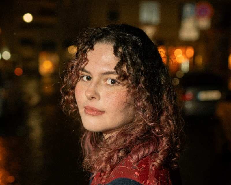 a woman with curly hair and a red shirt