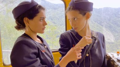 two women in uniform looking at each other