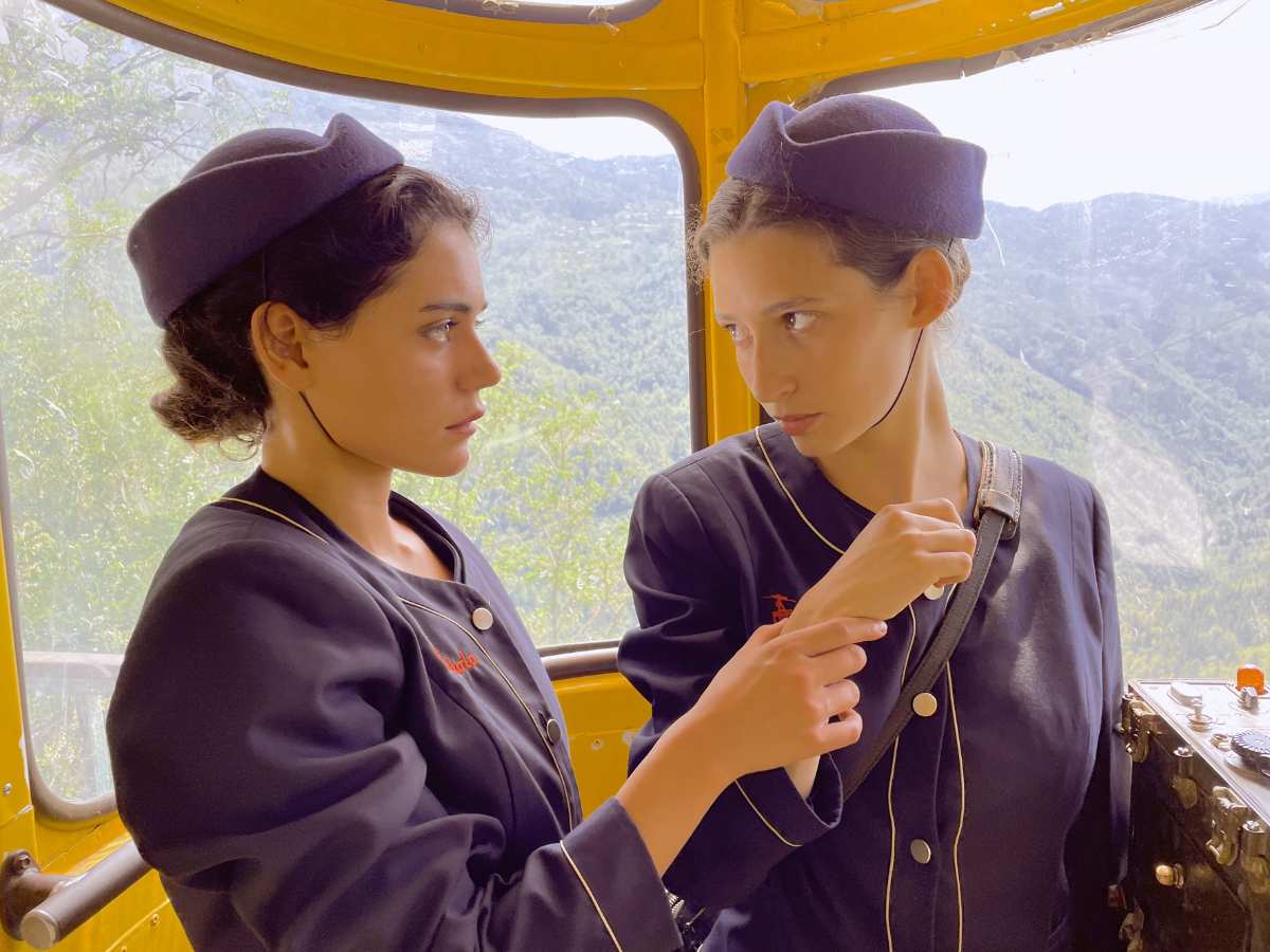 two women in uniform looking at each other