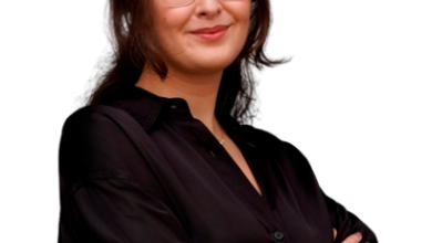 a woman with glasses and a black shirt