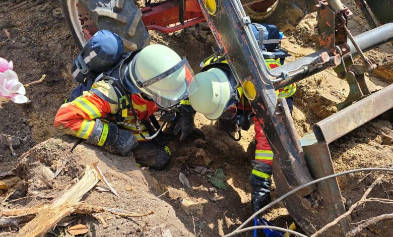a group of firefighters working on a tractor