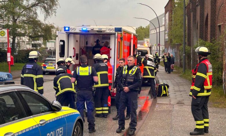 a group of people in uniform standing next to an ambulance