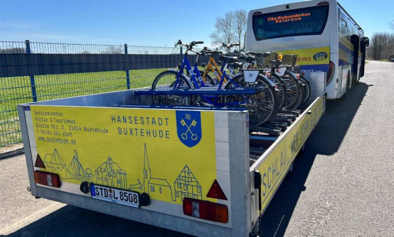a bus with a trailer full of bicycles