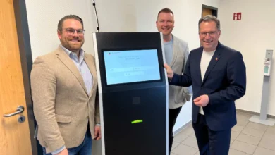 a group of men standing next to a machine