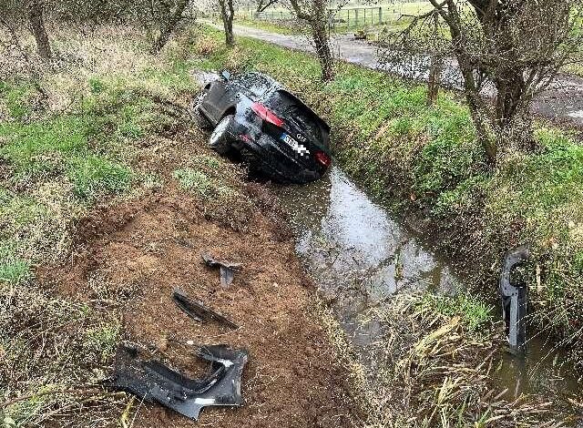 a car lying on a ditch