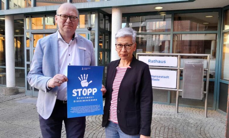 a man and woman holding a sign