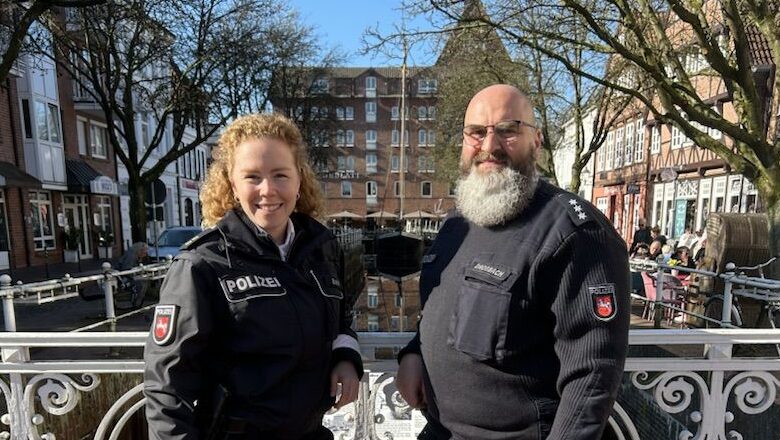 a man and woman in police uniforms