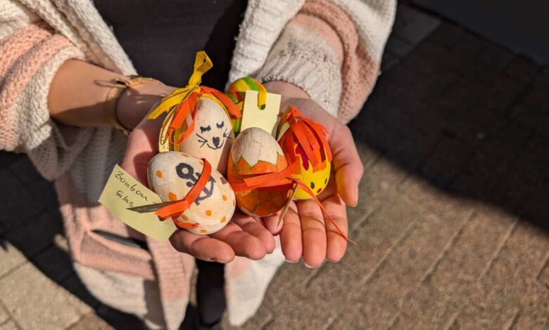 a person holding a group of decorated eggs