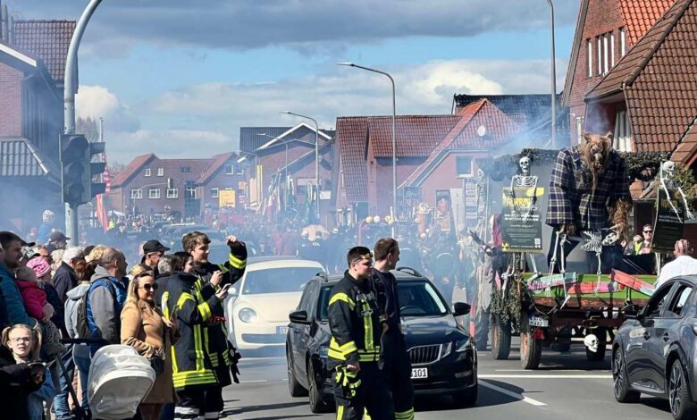 a group of people in firemen standing on a street