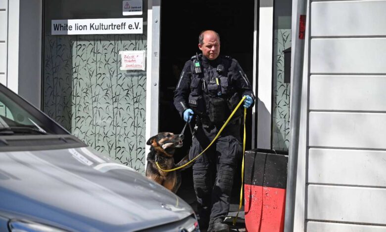 a man in uniform with a dog in the doorway of a building