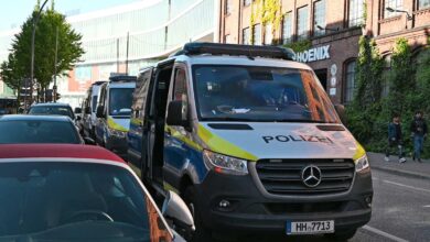 a group of police vans on a street