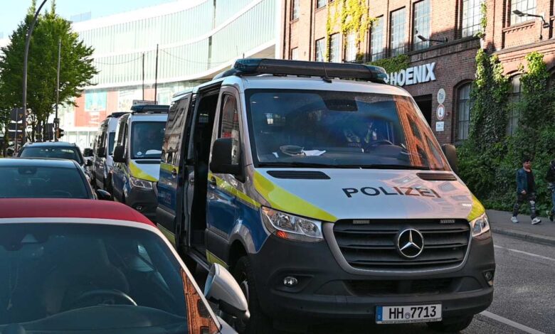 a group of police vans on a street