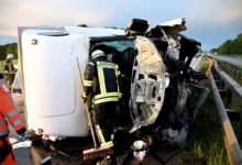 a firefighter sweeping the side of a wrecked vehicle