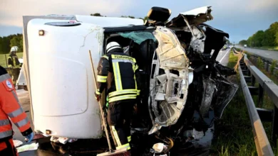 a firefighter sweeping the side of a wrecked vehicle