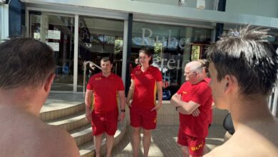 a group of people in red uniforms outside a building