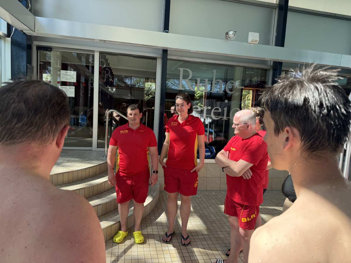 a group of people in red uniforms outside a building