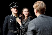 a man in a uniform and a woman in a black shirt