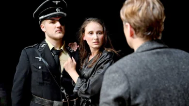 a man in a uniform and a woman in a black shirt