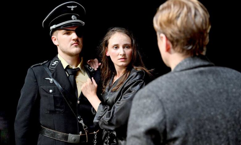 a man in a uniform and a woman in a black shirt