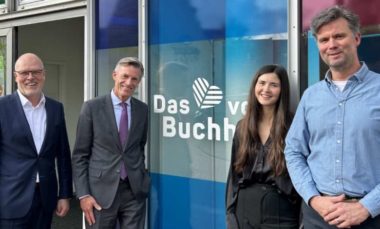 a group of people standing in front of a glass wall