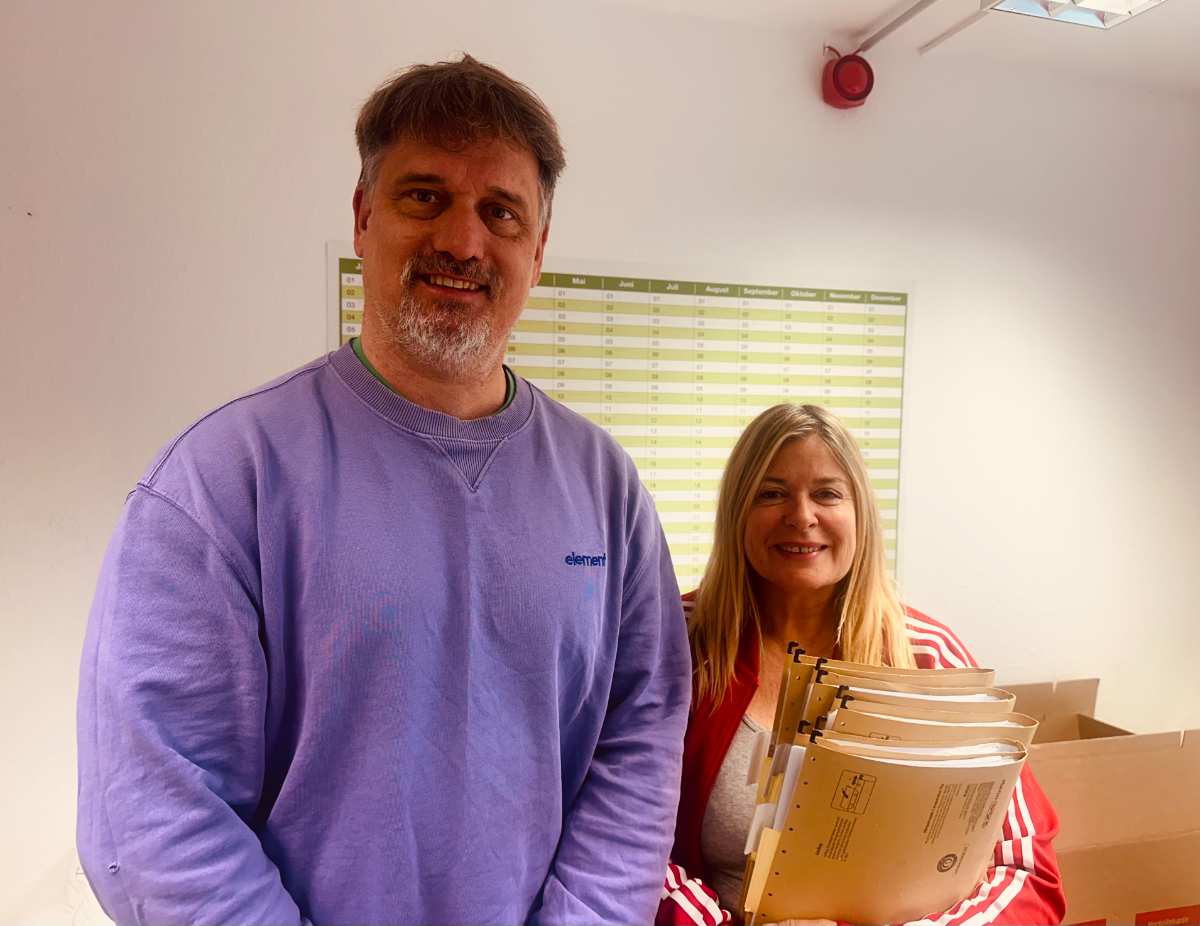 a man and woman holding files
