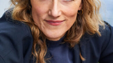 a woman wearing a hat and smiling