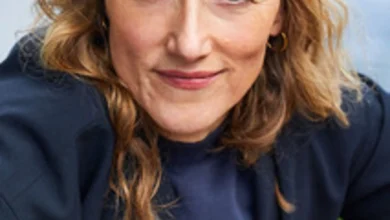 a woman wearing a hat and smiling