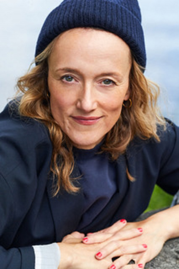 a woman wearing a hat and smiling