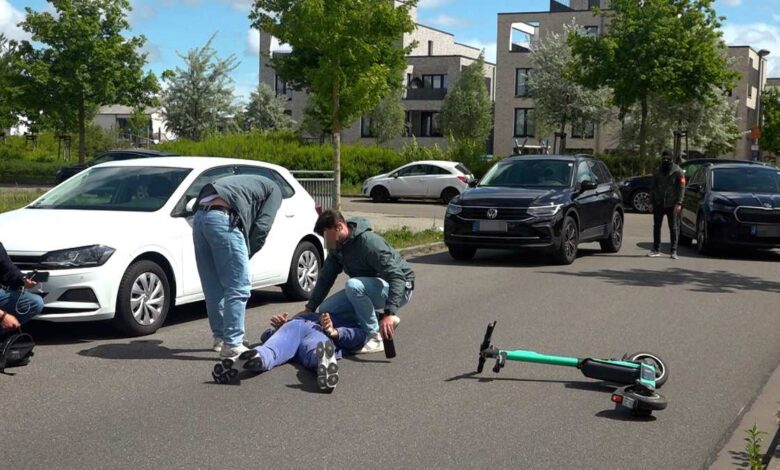 a man lying on the ground with another man on the ground