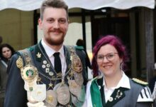 a man and woman wearing medals