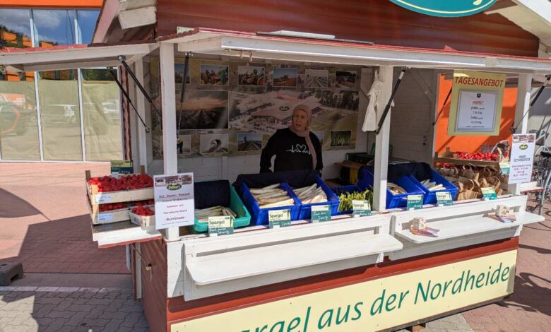 a man standing in front of a food stand