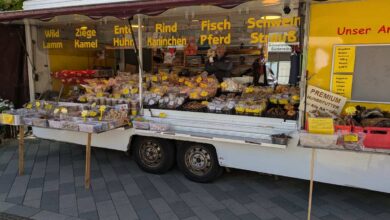 a food stand with a man standing in front of it