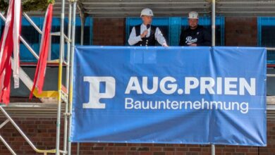 two men standing on a scaffolding